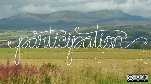 Participation lettering over a field and mountain landscape