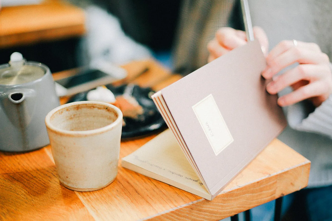 Notebook and a cup of coffee on a café table.